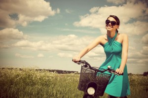 beautiful-girl-riding-bicycle-in-a-grass-field